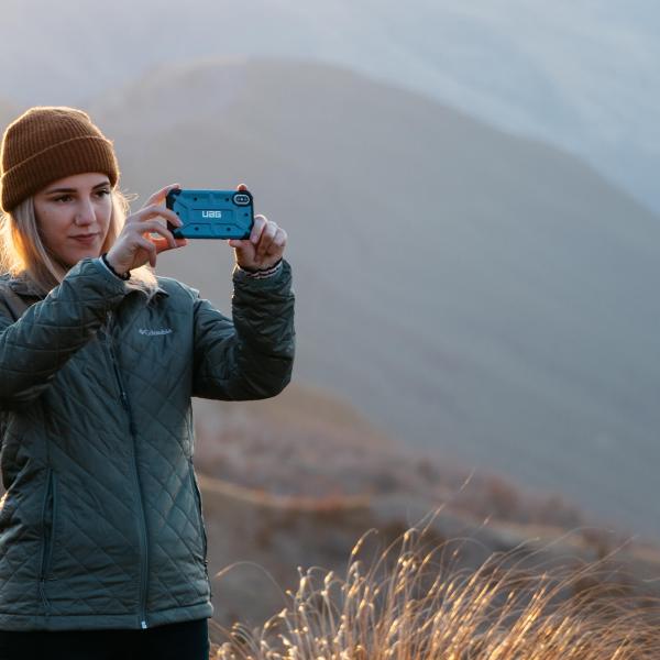 a person standing in front of a mountain