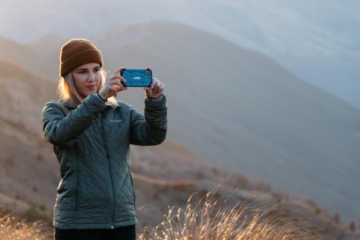 a person standing in front of a mountain