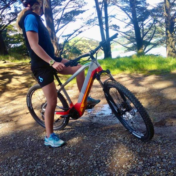 a person riding a bike down a dirt road