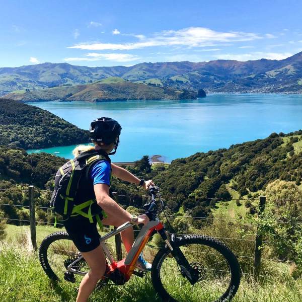 a bicycle next to a body of water with a mountain in the background