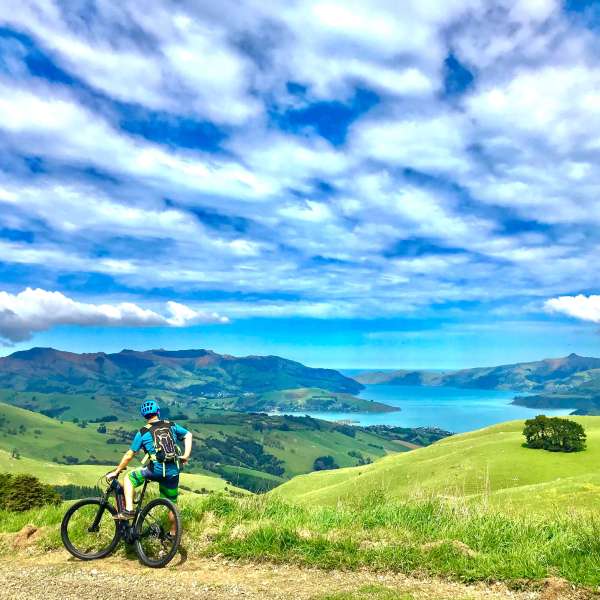a man riding a bike down a dirt road