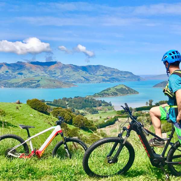 a young boy standing next to a bicycle