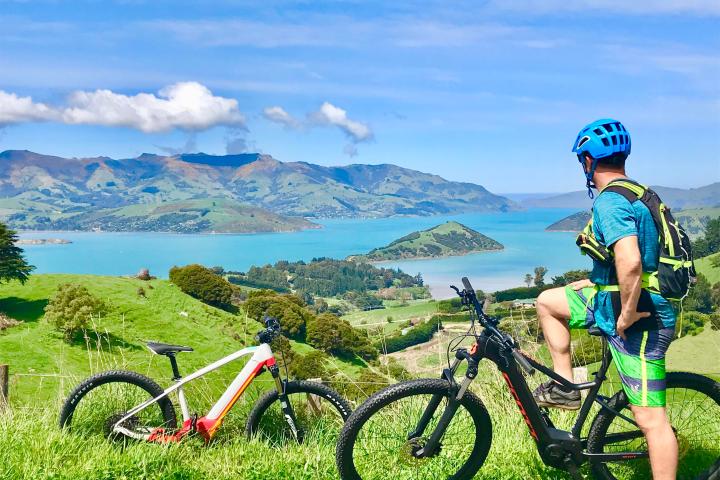 a young boy standing next to a bicycle