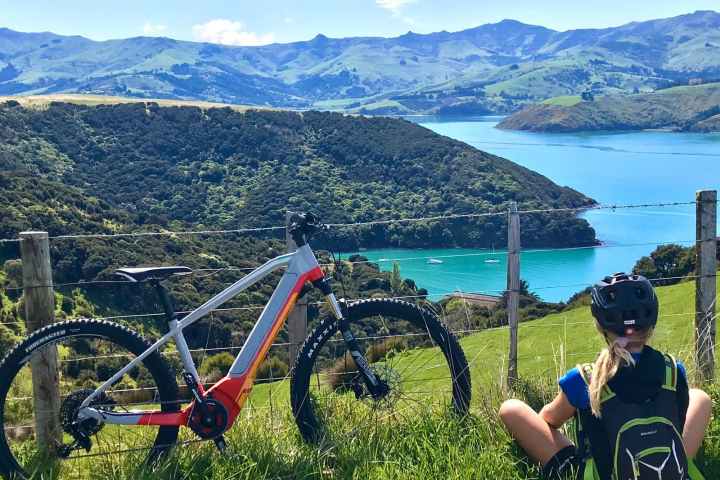 a group of people sitting in front of a body of water